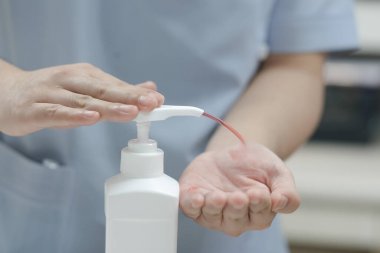 A man using alcohol gel for cleaning hands