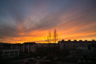 bright orange sunset over city buildings