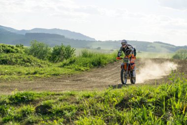 City: Zilina, Country: Slovakia. Date: 4-Apr-2018: Motorcyclist riding off road during sunset. Not an oofficial event. Slovakia 