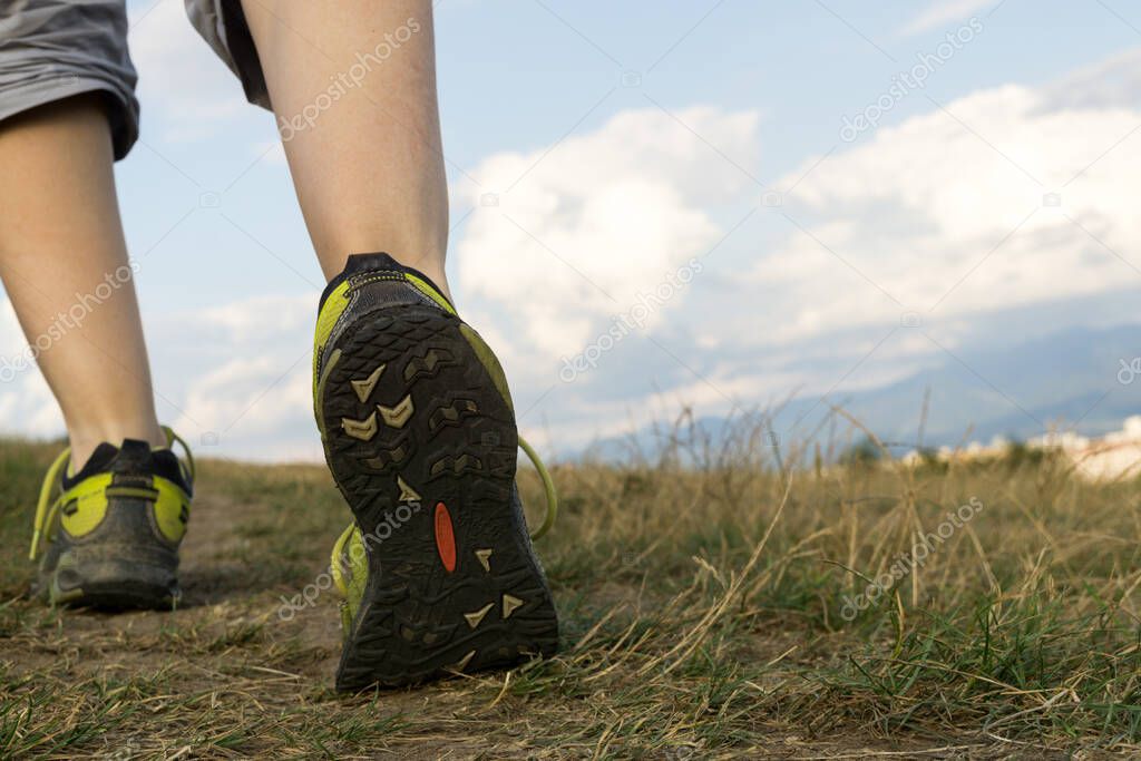 Woman in running shoes on the meadow. Slovakia