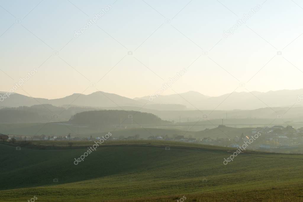mountain landscape with green grass and blue sky