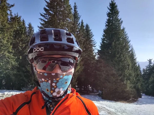 Cyclist Woman with helmet and sunglasses in the respirator mask in the nature. Slovakia