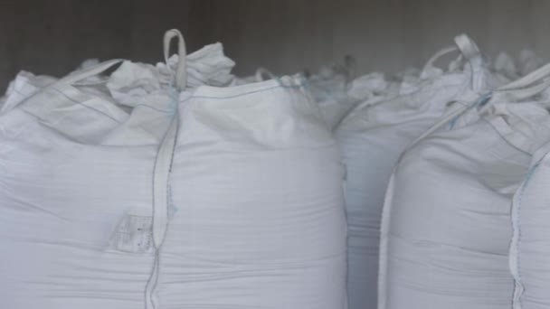 Closeup of white sacks for agriculture on a warehouse — 비디오