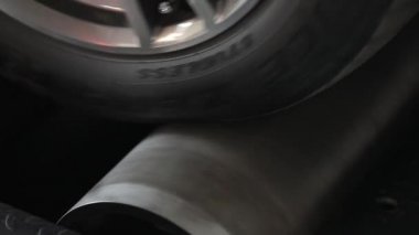 Automobile on stand for measuring car power.
