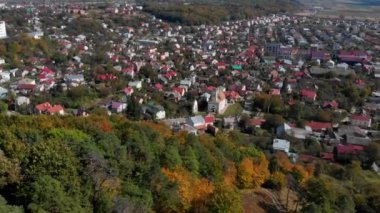 En tepedeki sonbahar tahtası. Doğa geçmişi. Renkli ağaçlarla dolu sonbahar ormanının havadan görünüşü.