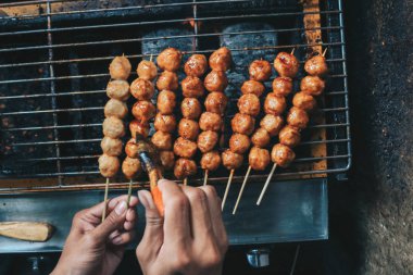 Izgarada köfte pişiren kişi.