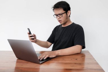 young surprised asian man working in studio