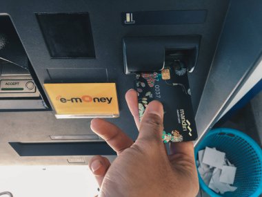 Adamın eli ATM 'den kredi kartı alıyor.