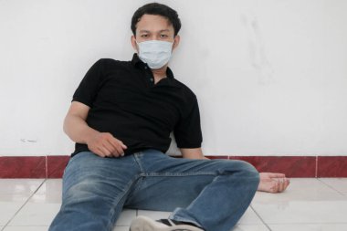 Maskeli genç Asyalı acı çekiyor.