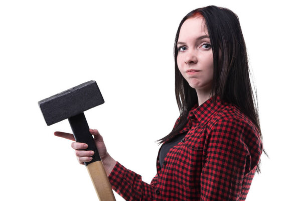 Puzzled young brunette with big hammer