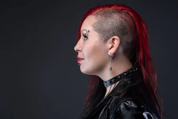 Punk woman in leather jacket, profile