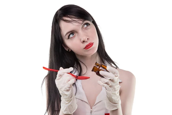 Brunette nurse dripping liquid drug — Stock Photo, Image