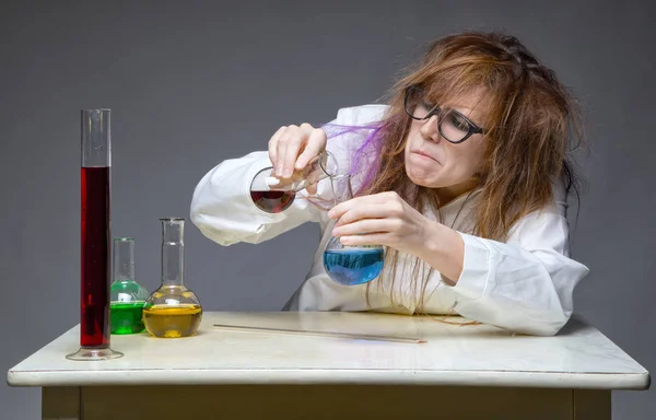 Mixing shaggy chemist in lab — Stock Photo, Image