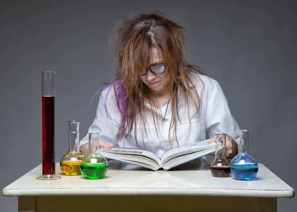 Reading frowned scientist with glass flask