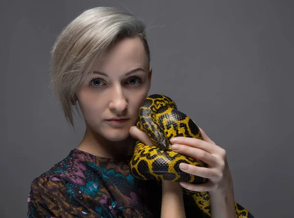 Blond woman holding anaconda — Stock Photo, Image