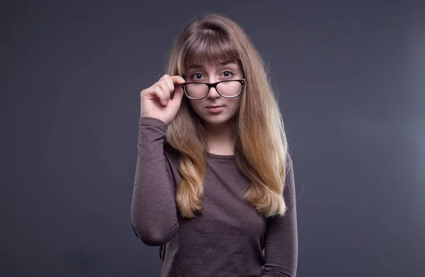 Welcoming teenage girl in glasses