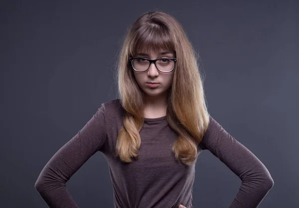 Skeptical teenage girl in glasses — Stock Photo, Image