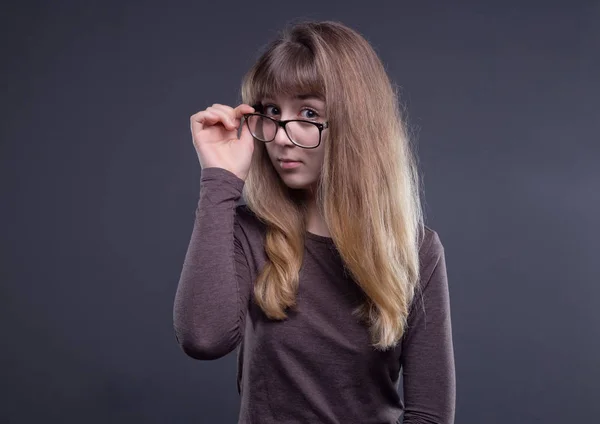 Welcoming young girl in glasses — Stock Photo, Image