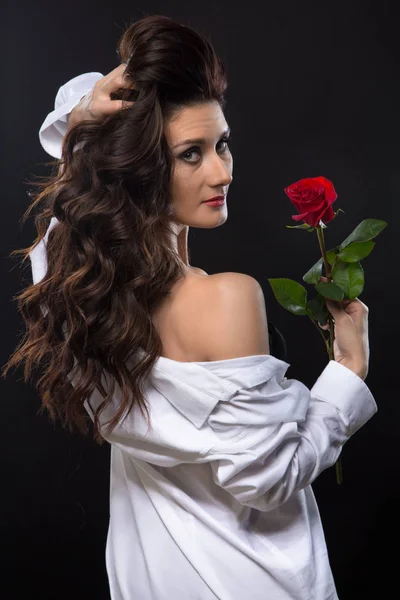 Brunette woman with red rose from back — Stock Photo, Image