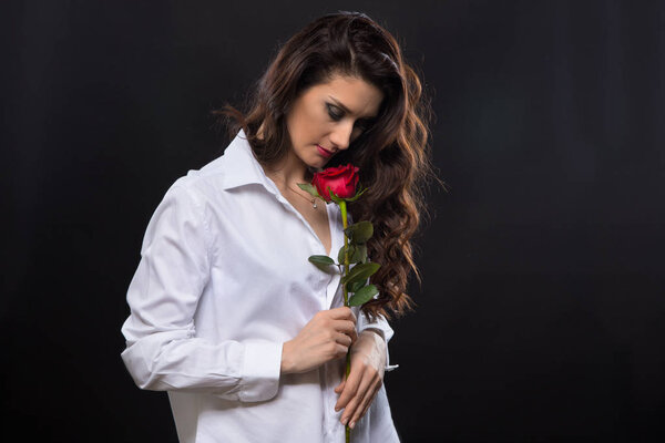 Curly woman with red rose