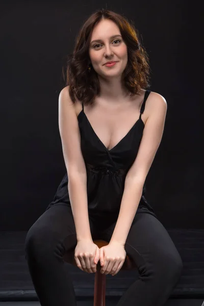 Portrait of sitting young brunette woman — Stock Photo, Image