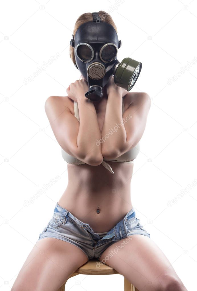 Sitting woman in gas mask covered breast