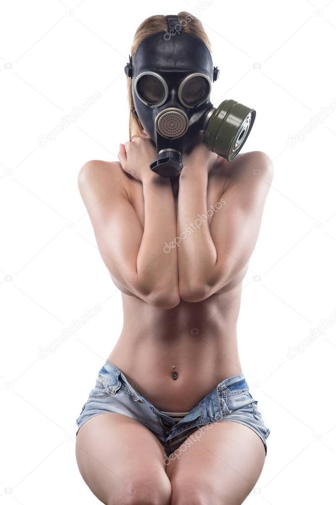 Sitting woman in gas mask covered chest