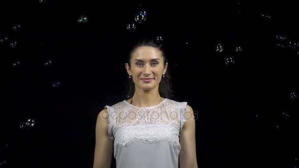 Красивая молодая женщина и падающие мыльные пузыри — стоковое видео