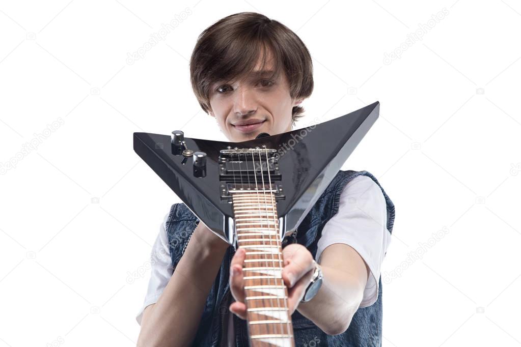 Young man showing electric guitar