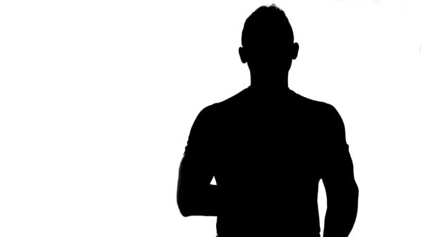 Silhouette of man with arms crossed — Stock Video