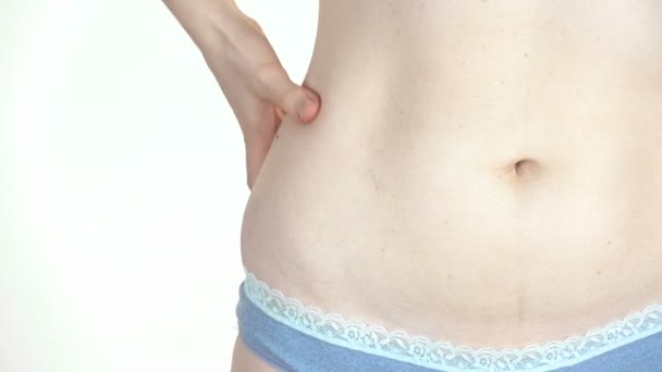 Young woman touching her flabby belly — Stock Footage Young woman touching her flabby belly Stock Video