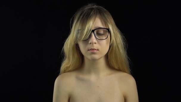 Blond girl in glasses looking at camera — Stock Video