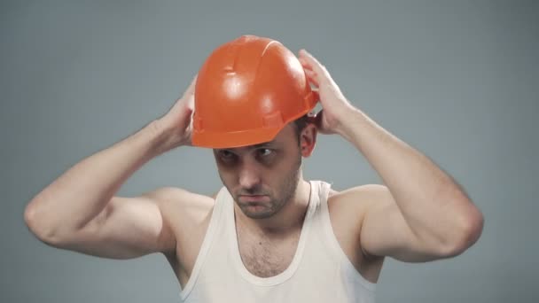 주황색 헬멧을 쓰고 있는 남자의 모습 — 비디오