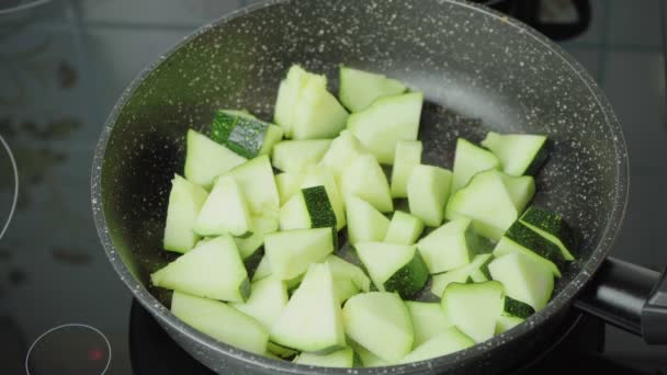 Video vom Kochen geschmorter Zucchini in der schwarzen Pfanne — Stockvideo
