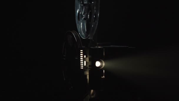 Shooting of old projector filming on black background — Stock Video