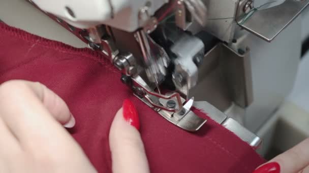 Shooting of woman sewing dress on electric overlock — Stock Video