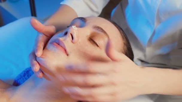 Vídeo de mulher jovem recebe um curso de massagem facial — Vídeo de Stock