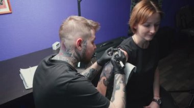 Video of young master getting tattoo of snake in studio