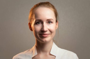 Image of the young smiling cute ginger woman