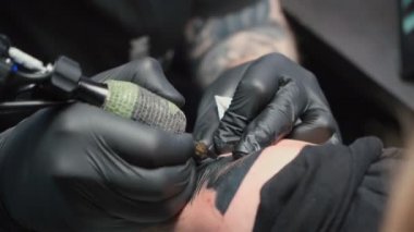 Footage of professional getting tattoo of snake, closeup