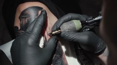 Video of man doing tattoo of snake for woman