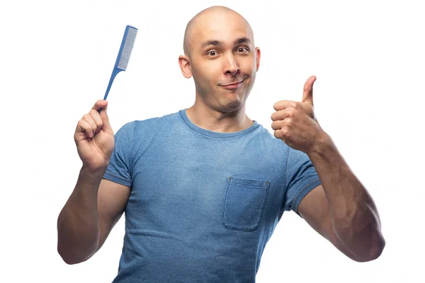 Image of young bald man in blue tee shirt with hairbrush — Stok fotoğraf