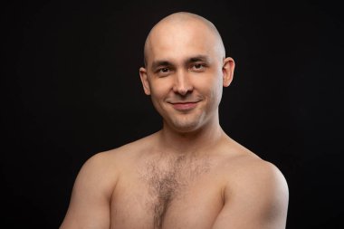 Photo of bald man with bare shoulders