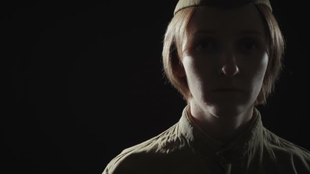 Video of young woman wearing soviet uniform in shadow — Stock Video