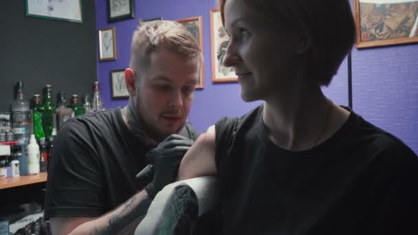 Young tattooer getting tattoo of snake in salon — 비디오