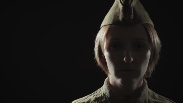 Video of young woman wearing red army uniform in shadow — Stock Video