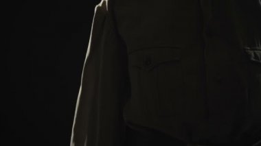 Video of woman wearing soviet uniform in shadow