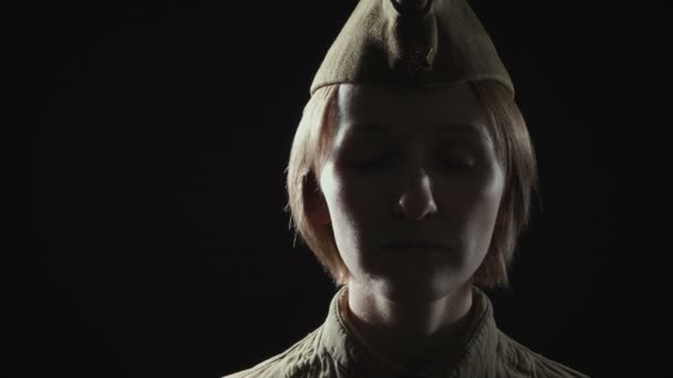 Young woman wearing soviet red army uniform in shadow — Stock Video