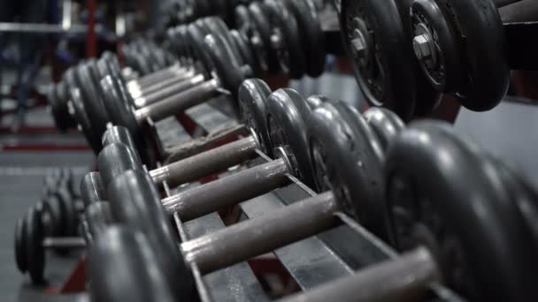 Video rack with dumbbells in fitness gym — 图库视频影像