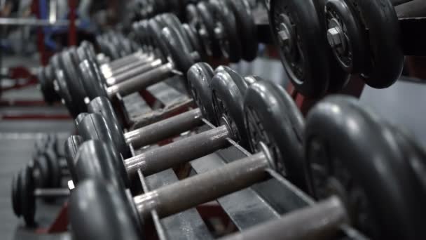 Rack with dumbbells in fitness gym — Stock Video